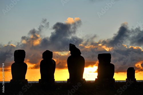 Easter Island. Statues of moai on the shore of the Pacific Ocean in the evening.
