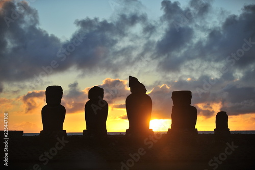 Easter Island. Statues of moai on the shore of the Pacific Ocean in the evening.