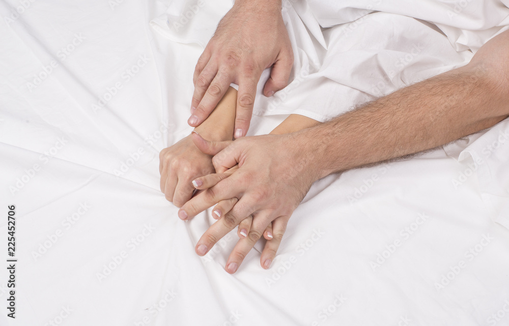 Close up hands of a couple make love hot sex on a bed. Close up hands of a couple make love hot sex on a bed.
