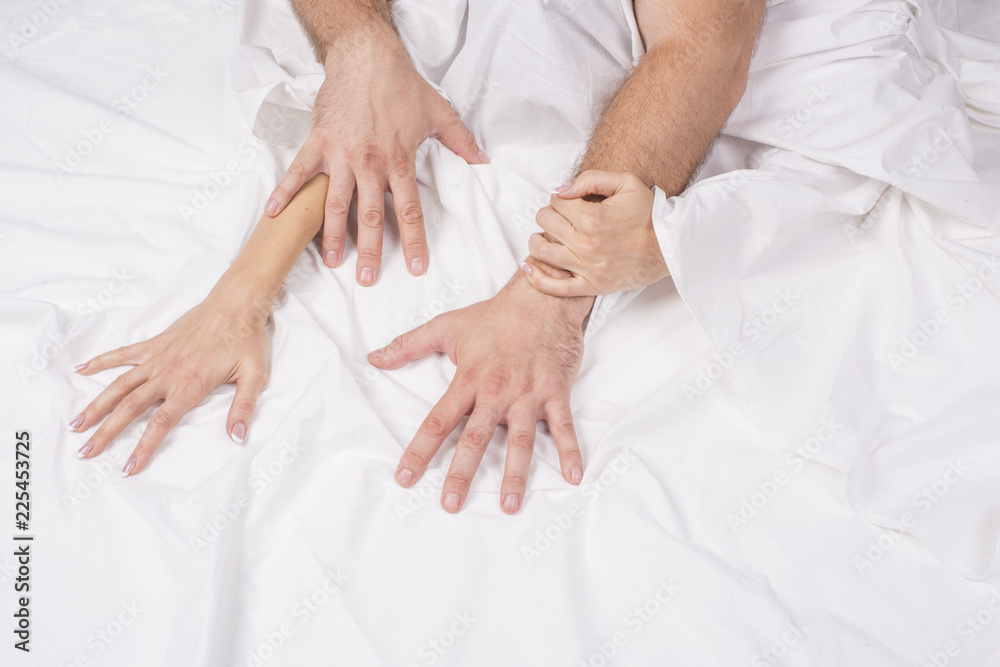 Close up of passionate couple hold hands during making intense love in bedroom, lovers enjoy hot sex on white sheet, boyfriend and girlfriend relax having intimacy at home, reaching orgasm or ecstasy. Close up of passionate couple hold hands during making intense love in bedroom, lovers enjoy hot sex on white sheet, boyfriend and girlfriend relax having intimacy at home, reaching orgasm or ecstasy.