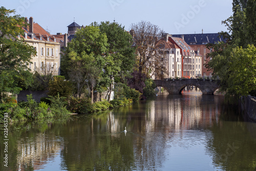 French river in Metz in France in the summer day with some classic houses on the banks