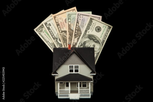 Model of a House with Money on Black Background