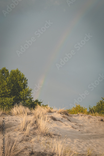 Rainbow over dunes. Regenboog over duinen in Burgh-Haamstede photo