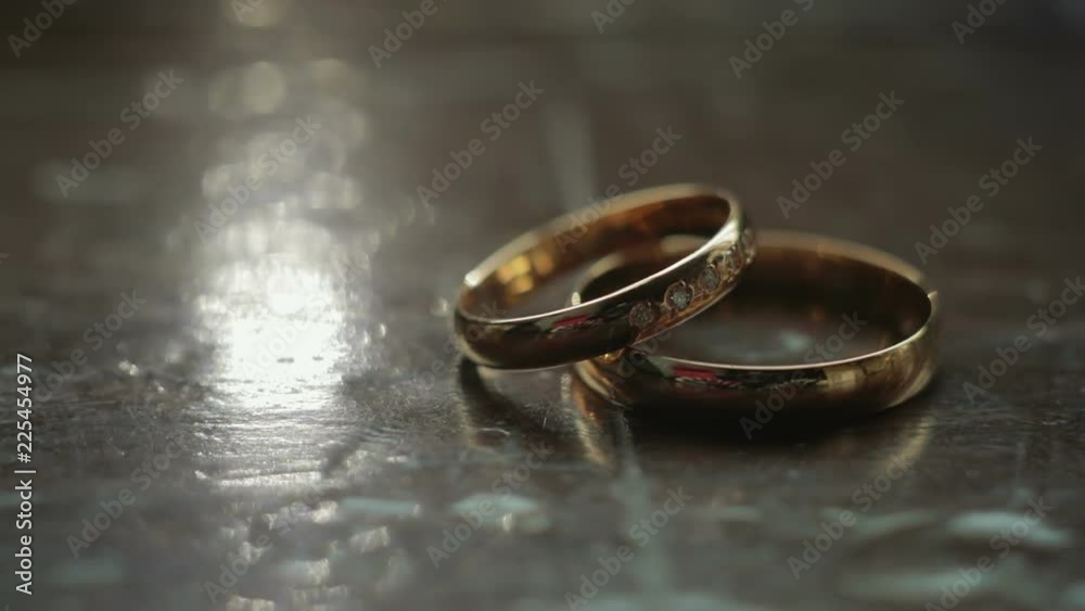 Two wedding rings lie on a wooden surface. Close up Two wedding rings lie on a wooden surface. Close up
