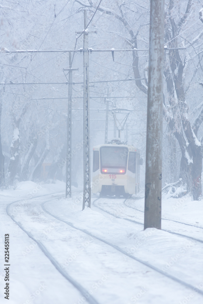 the tram goes on rails in the winter evening the tram goes on rails in the winter evening