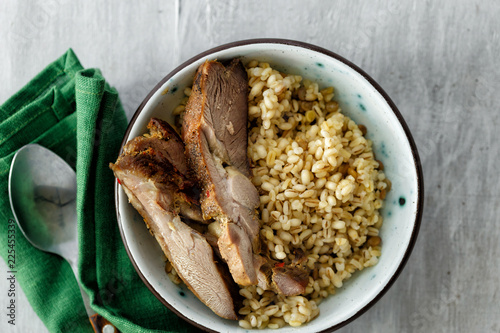 Healthy food porridge baked turkey meat bowl white wooden table top view photo