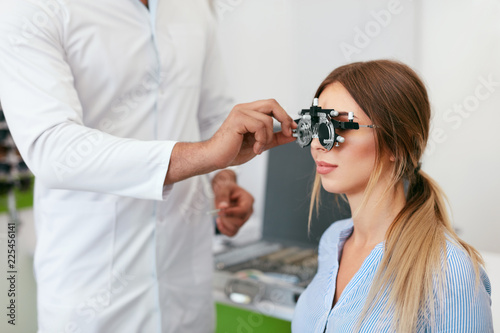 Obraz na plátně Eye Exam. Woman In Glasses Checking Eyesight At Clinic