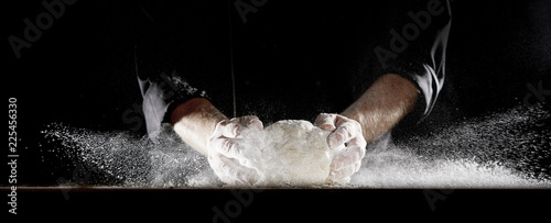 Cloud of flour caused by chef slamming dough