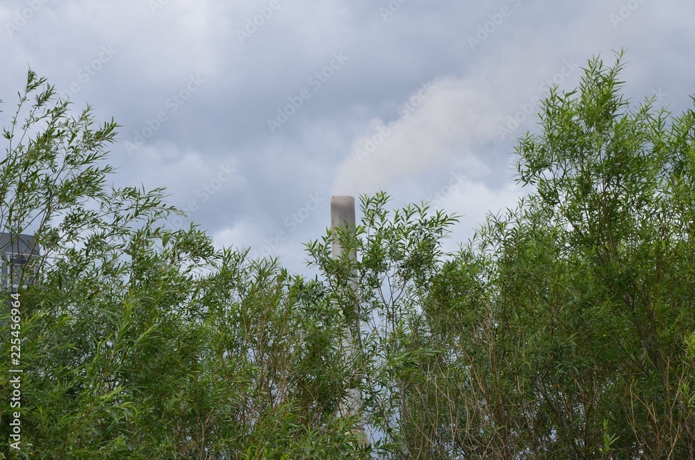 A funnel of a factory smokes in the air A funnel of a factory smokes in the air