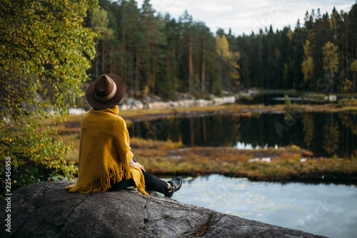 Young woman with hat at national park near lake