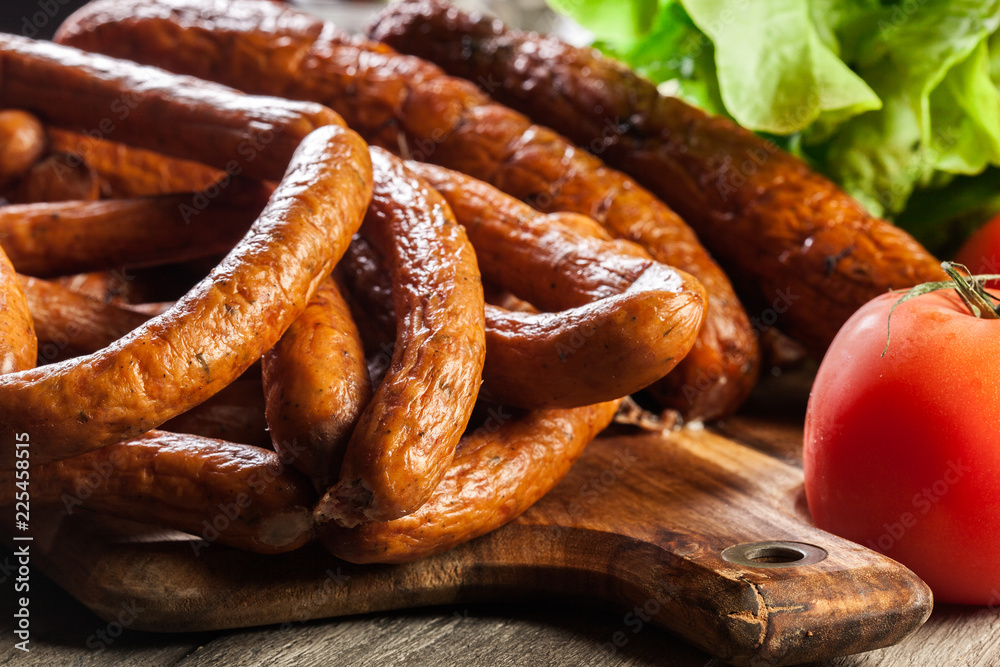 Assorted smoked sausages on a cutting board Assorted smoked sausages on a cutting board