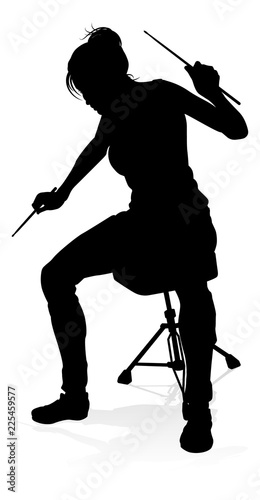 A drummer musician drumming drums in detailed silhouette