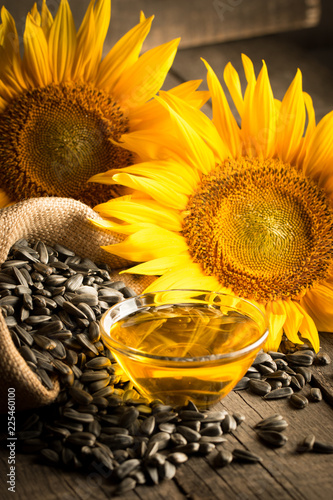 Bild auf Leinwand Closeup photo of sunflower oil with seeds on wooden background