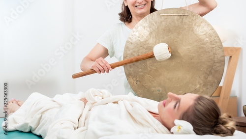 Fotografía Smiling woman relaxing in spa while masseuse making sound