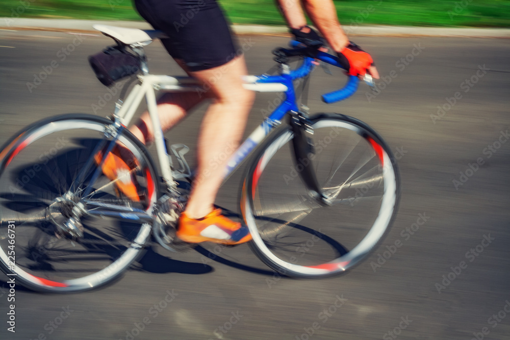 Racing bicycle in blurred motion speeding down the road. Racing bicycle in blurred motion speeding down the road.