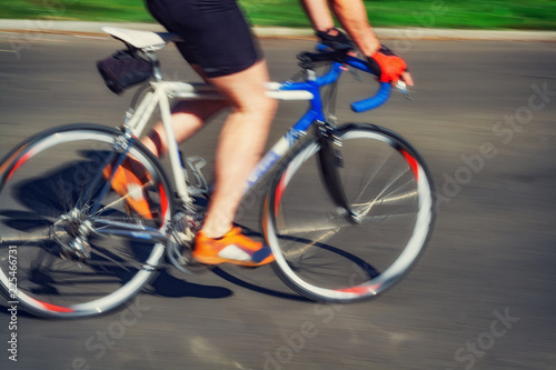 Racing bicycle in blurred motion speeding down the road.