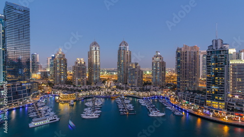 Dubai Marina skyscrapers aeral day to night timelapse, port with luxury yachts and marina promenade © neiezhmakov