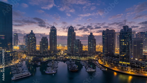 Aerial view of modern skyscrapers night to day timelapse before sunrise in Dubai Marina in Dubai, UAE. © neiezhmakov