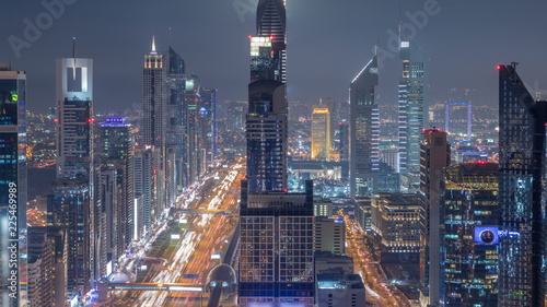 Scenic Dubai downtown skyline at night timelapse. Rooftop view of Sheikh Zayed road with numerous illuminated towers. photo