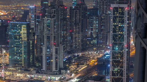 Dubai Downtown night timelapse modern towers view from the top in Dubai, United Arab Emirates. photo