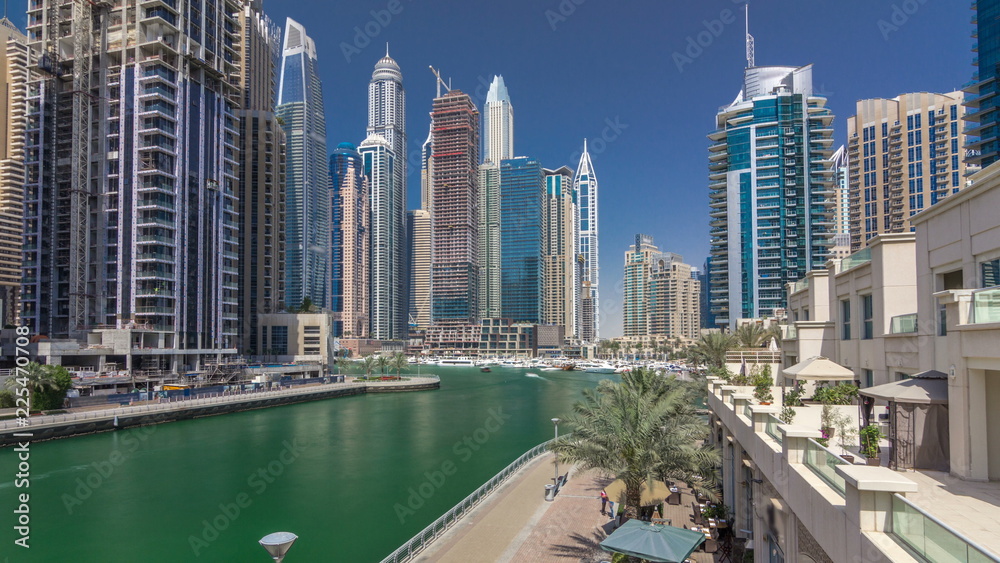 Panoramic view with modern skyscrapers and yachts of Dubai Marina timelapse hyperlapse, United Arab Emirates