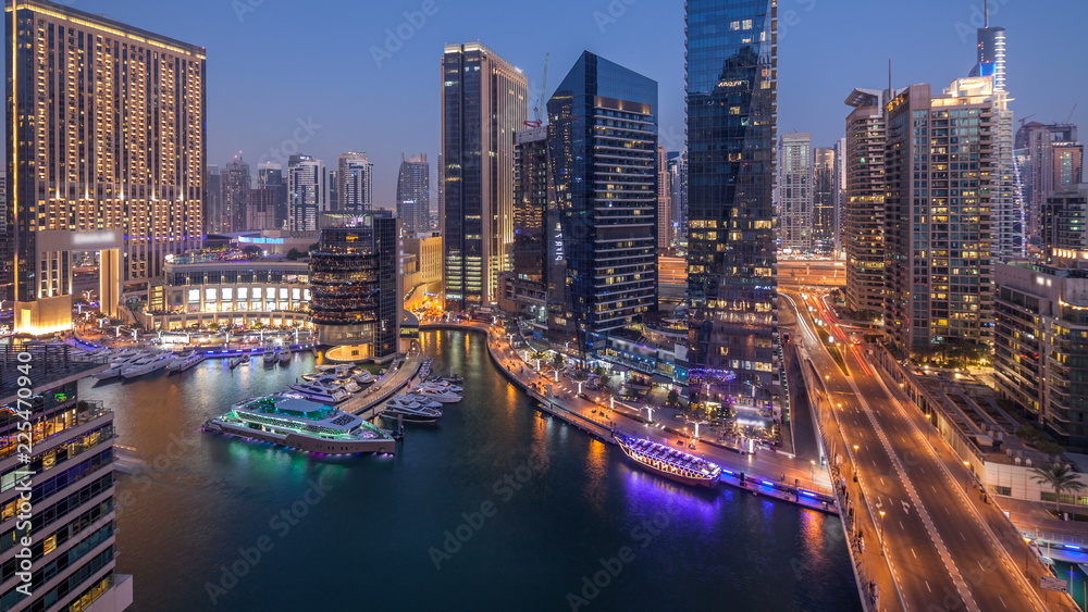 Fototapeta premium Beautiful aerial top view day to night transition timelapse of Dubai Marina canal