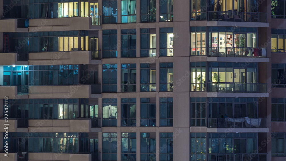 Glowing windows of skyscrapers at evening timelapse