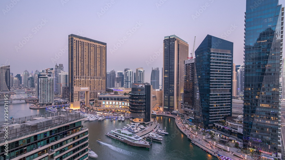 Fototapeta premium Beautiful aerial top view day to night transition timelapse of Dubai Marina canal