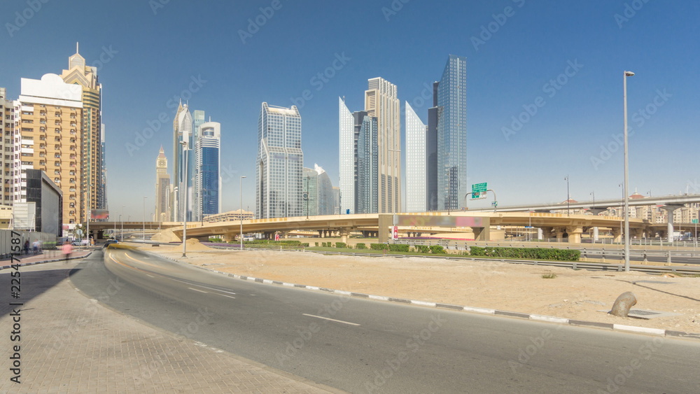 Busy Sheikh Zayed Road timelapse hyperlapse, metro railway and modern skyscrapers around in luxury Dubai city