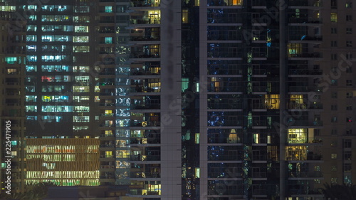 Glowing windows of skyscrapers at evening timelapse