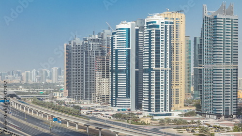 Aerial view of Jumeirah lakes towers skyscrapers timelapse with traffic on sheikh zayed road.
