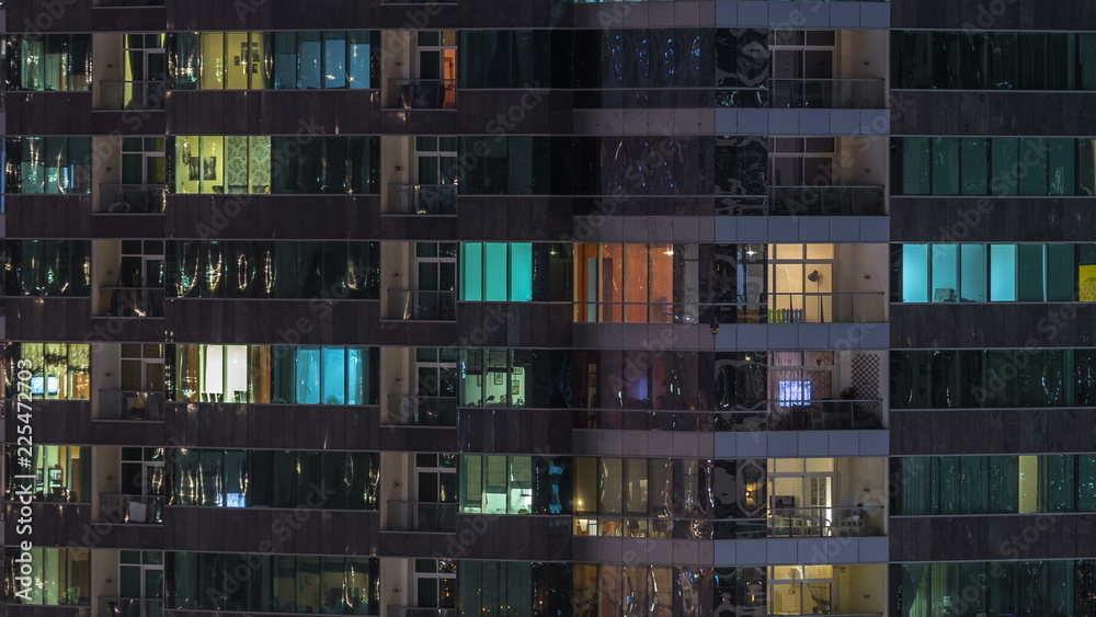 Windows of the multi-storey building of glass and steel lighting inside and moving people within timelapse Windows of the multi-storey building of glass and steel lighting inside and moving people within timelapse