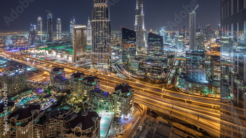 Dubai downtown skyline night timelapse with tallest building and road traffic, UAE