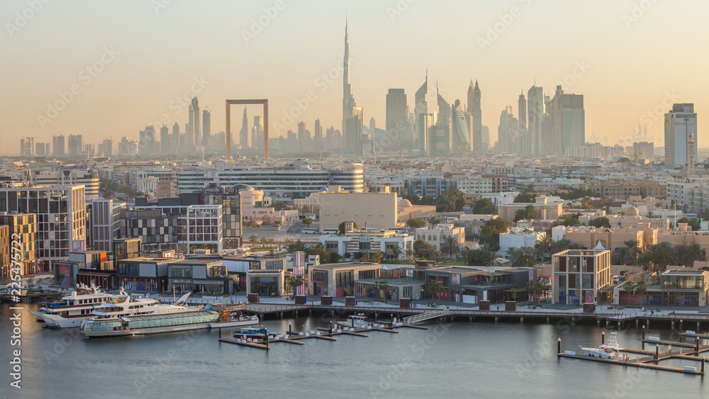Dubai creek landscape timelapse with boats and ship near waterfront and modern buildings in the background during sunset