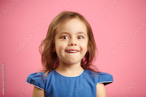 Astonished little girl with wide eyes, isolated portrait