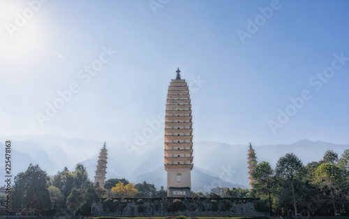 The Three Pagodas of the Chongsheng Temple are an ensemble of three independent pagodas arranged on the corners of an equilateral triangle, near the old town of Dali, Yunnan province, China. photo