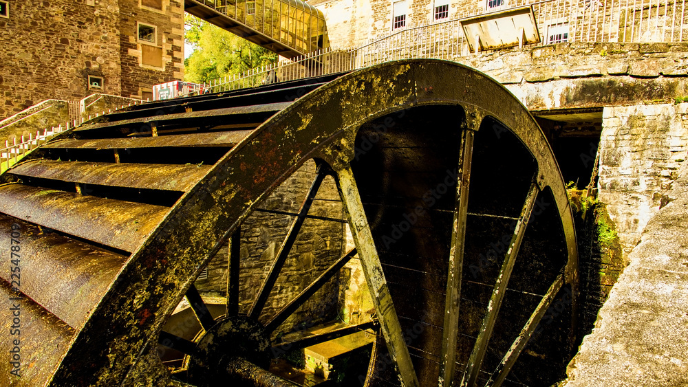 The historic village of New Lanark. A World Heritage Site in a deep valley next to the River Clyde. The water wheel.