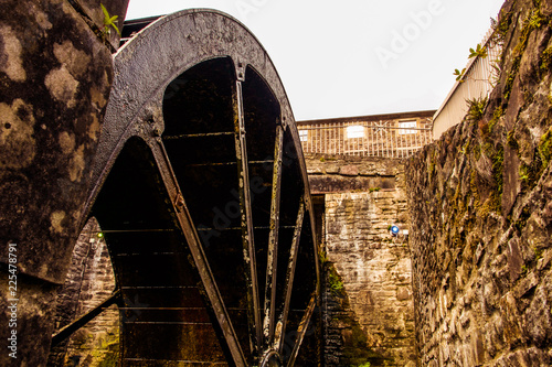 The historic village of New Lanark. A World Heritage Site in a deep valley next to the River Clyde. The water wheel.