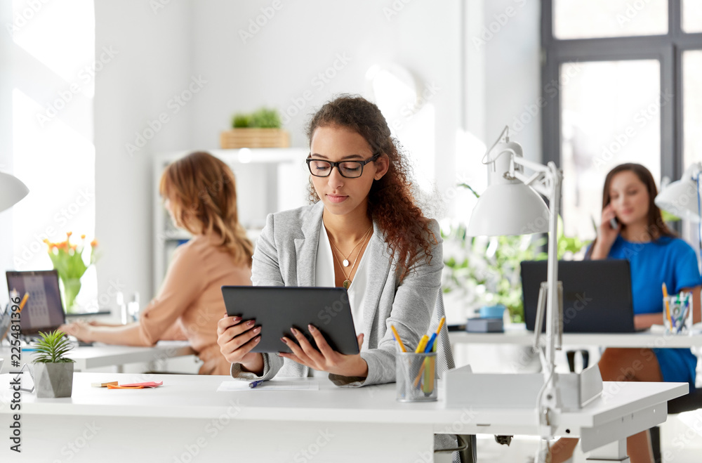 business, technology and people concept - african american businesswoman with tablet pc computer working at office