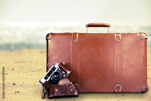 Brown leather vintage suitcase and camera