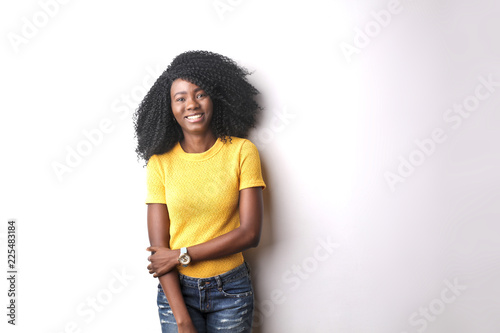 Portrait of smiling young woman in yellow tshirt