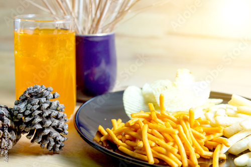 Relax time with juice and snacks on wooden table.