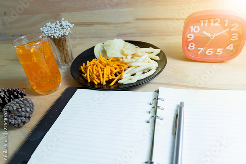 Relax time with juice and snacks on wooden table.