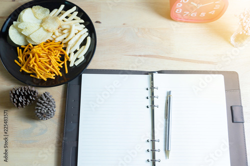 Relax time with juice and snacks on wooden table.