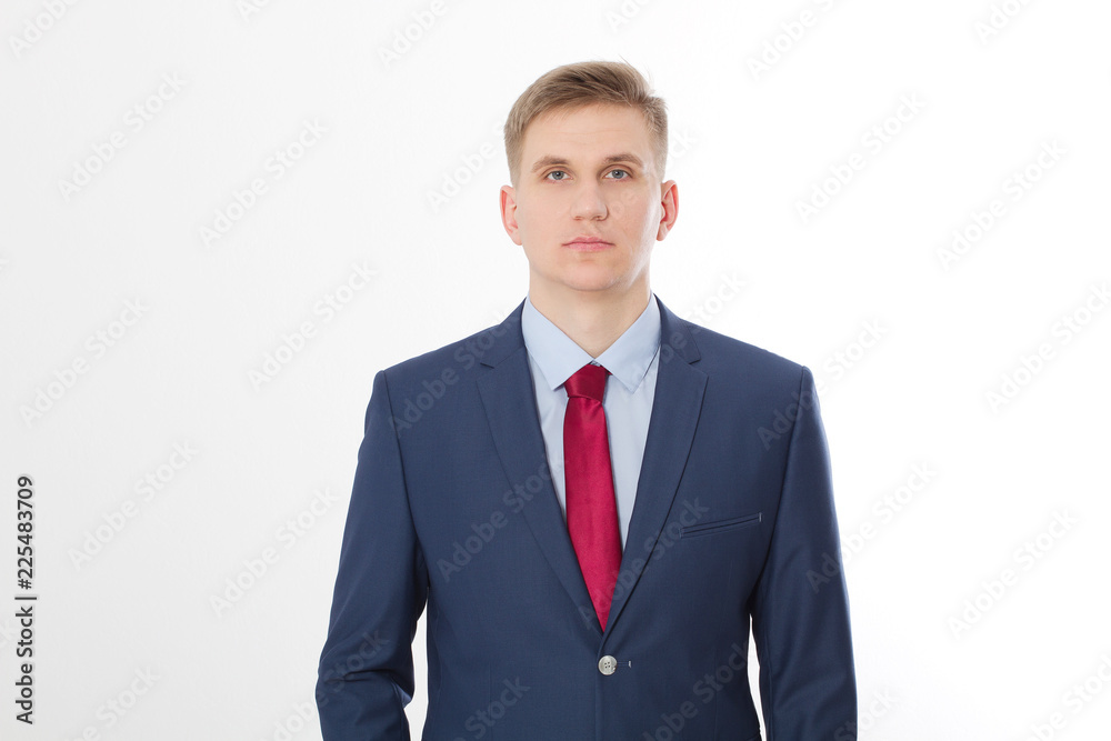 Serious businessman in blue suit and red tie isolated on white background. Business concept. Copy space and mock up Serious businessman in blue suit and red tie isolated on white background. Business concept. Copy space and mock up