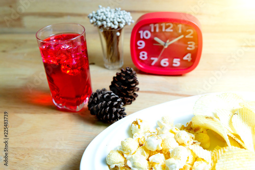 Relax time with juice and snacks on wooden table.