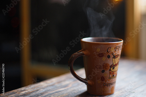 hot drink in a mug with steam on a dark background