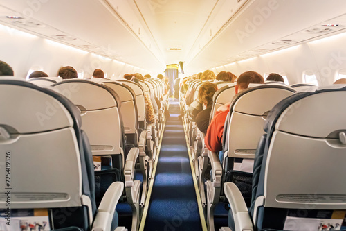 Canvastavla Commercial aircraft cabin with rows of seats down the aisle