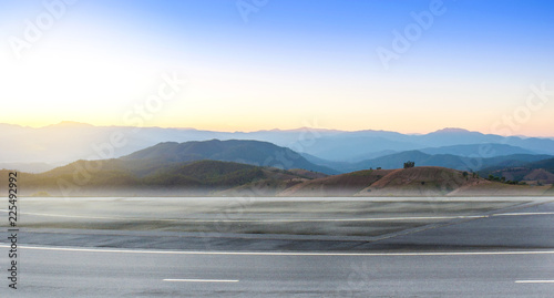 Empty highway asphalt road and beautiful landscape of countryside with mountain sky sunset time.