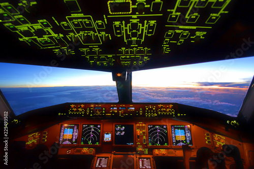 In cockpit, airplane flying over the cloud during sunset in the evening. Able to see beautiful twilight.